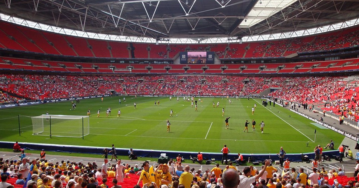 Wembley football stadium during a live match, with the pitch, players, and spectators visible in a large modern arena.